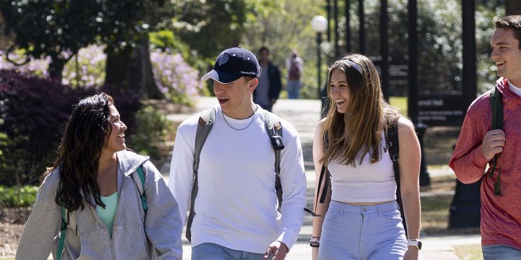 students walking and talking on camnpus